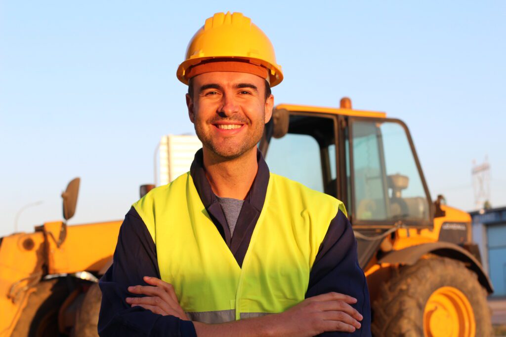 Construction driver with excavator on the background